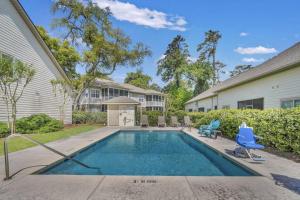 a swimming pool in front of a house at Brand New Listing: Comfy, Stylish & Convenient South Island Townhome! in Riverview