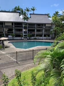 a swimming pool in front of a building at Lucy's Place -STUDIO Apt with air-conditioning, Murphy bed in Hilo