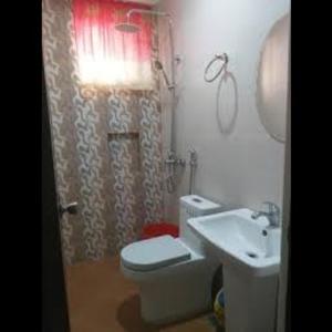 a bathroom with a toilet and a sink at Grand robertos inn bangued abra in Bangued