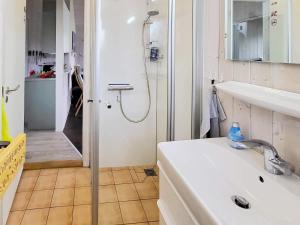 a white bathroom with a shower and a sink at Two-Bedroom Holiday home in Grömitz 3 in Grömitz