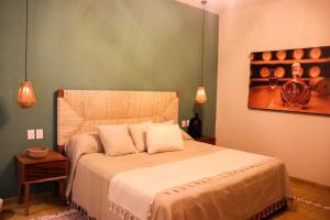 Postel nebo postele na pokoji v ubytování Hotel Boutique Gloriagave