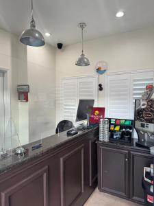 a kitchen with a counter with a computer on it at Moonlite Inn in Redondo Beach