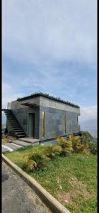 a small building on top of a hill at La casa en el aire in Medellín