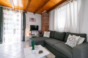 a living room with a couch and a tv at Apartments with parking space Vela Luka, Korcula - 20932 in Vela Luka