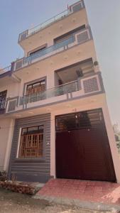 a building with two garage doors in front of it at Dreams Stay in Lucknow