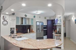 a kitchen with a large marble counter top at Dream Time Direct Beach Access in Agnes Water