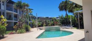 a swimming pool in front of a apartment building at Dream Time Direct Beach Access in Agnes Water
