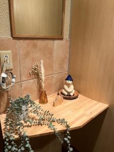 a wooden counter with a figurine on top of it at ROOM龍ヶ崎 -Adult only- in Ushiku