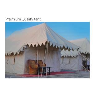 a large white tent with a chair in it at Surkhab rann resort in Dhordo