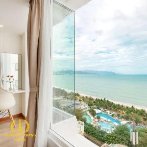 a room with a window with a view of the ocean at Paris Nha Trang Hotel in Nha Trang