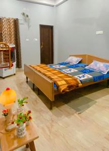 a bedroom with a bed and a table in it at Dreams Stay in Lucknow