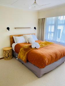 a bedroom with a bed with two towels on it at Rosedale Retreat in Invercargill