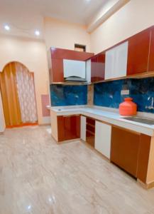 a kitchen with blue and white walls and a counter at Dreams Stay in Lucknow