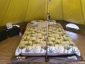 a bedroom with a bed in a tent at Eureka Station Camping Retreat in Apple Tree Creek