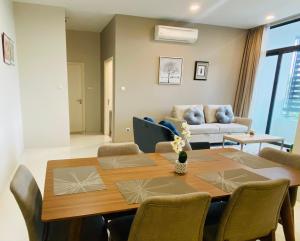 a living room with a table and a couch at 2BD @ USS & Car (Optional) in Kuching