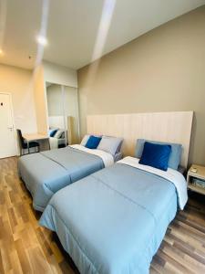 two beds sitting next to each other in a room at 2BD @ USS & Car (Optional) in Kuching +22 photos