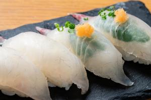 a group of sushi on a black plate at Advance Gojo 205 - Vacation STAY 23022v in Goto
