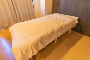 a bed in a room with a white blanket at Advance Gojo 205 - Vacation STAY 23022v in Goto