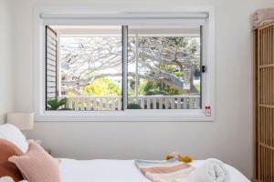 淺灘灣的住宿－Shoal Bay Beach House One，卧室设有窗户,享有树木美景
