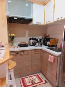a small kitchen with a sink and a stove at Congressional Town Center in Manila