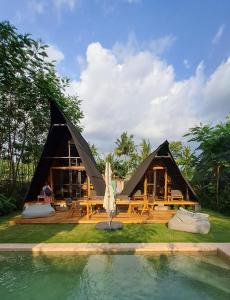 a large tent with a pool in front of it at Villa Verde the garden in Yogyakarta