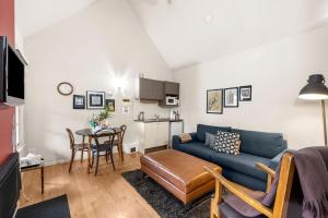 a living room with a couch and a table at Circa Red London Daylesford in Daylesford