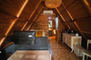 a large room with a bed in a cabin at Villa Verde the garden in Yogyakarta