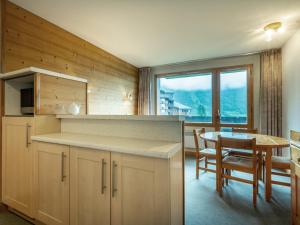 a kitchen and dining room with a table and a window at Appartement Valmorel, 2 pièces, 4 personnes - FR-1-356-248 in Valmorel