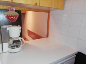 a kitchen counter with a coffee maker on it at Appartement Valmorel, 1 pièce, 4 personnes - FR-1-356-284 in Valmorel