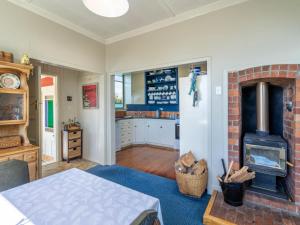a living room with a fireplace and a kitchen at Beachhouse View in Riverton