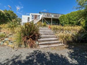 a set of stairs leading to a house at Beachhouse View in Riverton