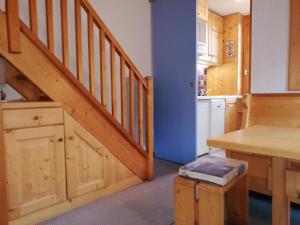 a kitchen with a wooden staircase in a house at Appartement Valmorel, 2 pièces, 4 personnes - FR-1-356-188 in Valmorel