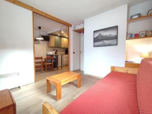 a living room with a couch and a table at Appartement Valmorel, 1 pièce, 4 personnes - FR-1-356-257 in Valmorel