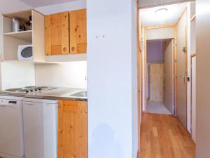 a kitchen with white appliances and wooden cabinets at Appartement Valmorel, 2 pièces, 4 personnes - FR-1-356-330 in Valmorel