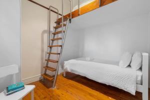 a bedroom with a ladder next to a bed at Charming 3 Bedroom Artist House in Mosman in Sydney