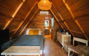 a bedroom with a bed in a room with wooden walls at Villa Verde the garden in Yogyakarta +36 photos