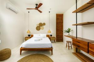 a bedroom with a bed and a ceiling fan at Terra Resort in Ahangama