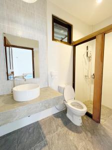 a bathroom with a toilet and a sink at ครูหนูบ้านพัก แหลมงอบ Krunou baanpak in Trat