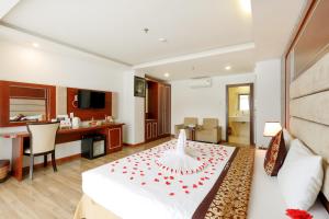a hotel room with a bed and a desk at Paris Nha Trang Hotel in Nha Trang