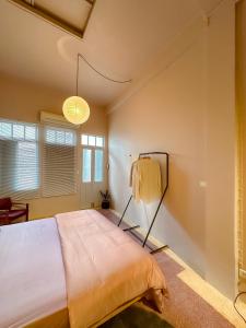 a bedroom with a large bed in a room at Cozy Room at The Coffee Store Charoenkrung in Bangkok