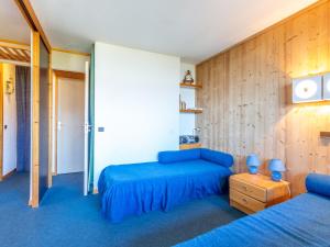 ラ・プラーニュにあるAppartement La Plagne, 1 pièce, 4 personnes - FR-1-353-71のベッドルーム1室(青いシーツと木製の壁のベッド2台付)