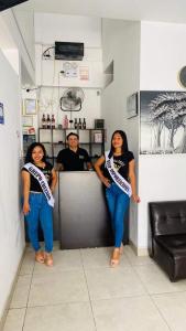 a man and two women standing at a counter at Hospedaje Moralillos in Yurimaguas