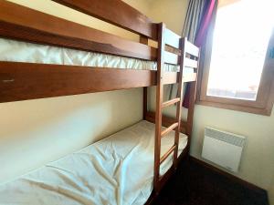 a couple of bunk beds in a room with a window at Appartement Plagne Soleil, 3 pièces, 6 personnes - FR-1-351-31 in Plagne Villages