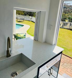 a kitchen sink with a view of a yard at Villa Le Rosa Unit 5 in Durban