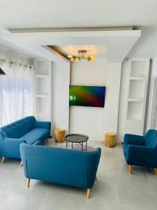 a living room with two blue couches and a table at Villa Le Rosa Unit 5 in Durban