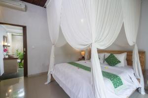 Voodi või voodid majutusasutuse Parthi Puri Ubud toas