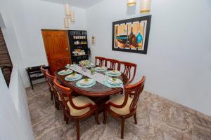 a dining room with a table and eight chairs at Amancay House in San Cristobal
