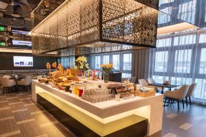 a restaurant with a buffet line with tables and chairs at Atour Hotel Shenzhen Huaqiangbei Commercial Center in Shenzhen