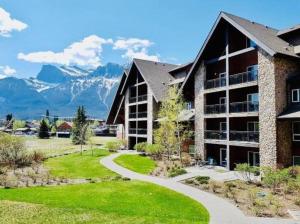 a resort with mountains in the background at Family Fun- MTN View Stay, Water slide, Pool, Hot Tub, Free Parking in Canmore