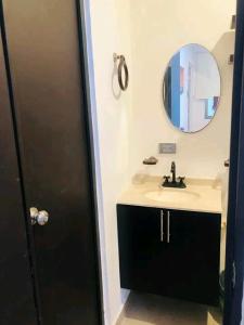 a bathroom with a sink and a mirror at Loft estudio centrico in Ciudad del Carmen